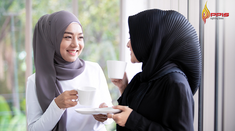 Muslim women colleagues socializing